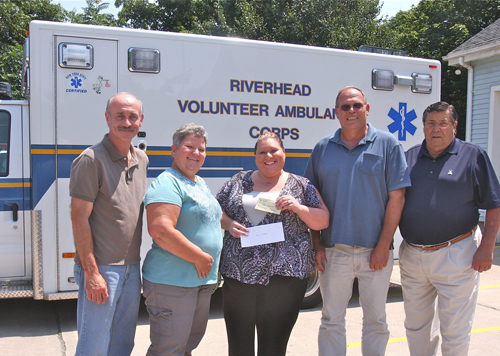 BARBARELLEN KOCH PHOTO | Riverhead Volunteer Ambulance Corp board president Kim Porkorny (center) and vice president Joe Sokoloski (far left) accepted donation s from 'Heidi's Helping Angels' honoree members (from left) June and John Behr and president Jim Stark Tuesday afternoon.