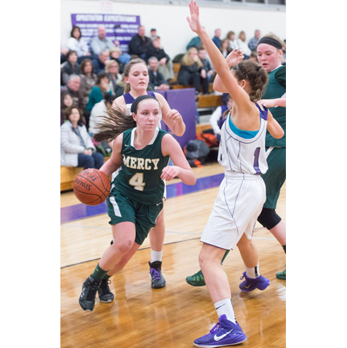 Mia Behrens drives to the basket Friday against Port Jefferson. (Credit: Robert O'Rourk)