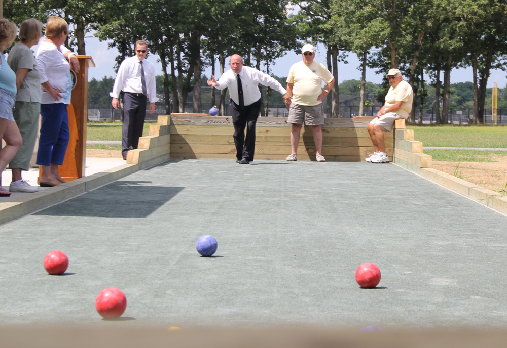 Town Board Member James Wooten giving it his best shot on the bocce court Tuesday. (Credit: Carrie Miller)