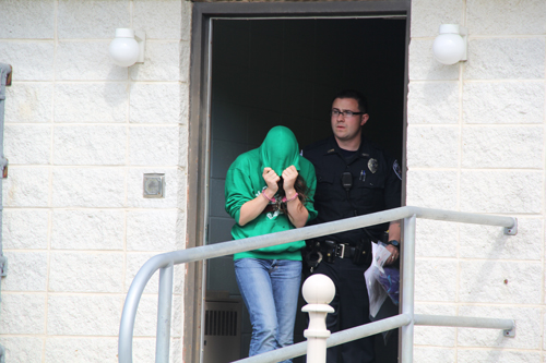 Jacqueline Celentano, 21, of Calverton is led out of Southampton Police Department headquarters in Hampton Bays Wednesday morning for a Justice Court appearance. (Credit: Carrie Miller file)