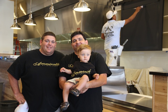 Brothers Steve (left) and Greg Ammirati and Greg’s 17-month-old son, Anthony, oversee the finishing touches at the deli on Wednesday. (Credit: Cyndi Murray)
