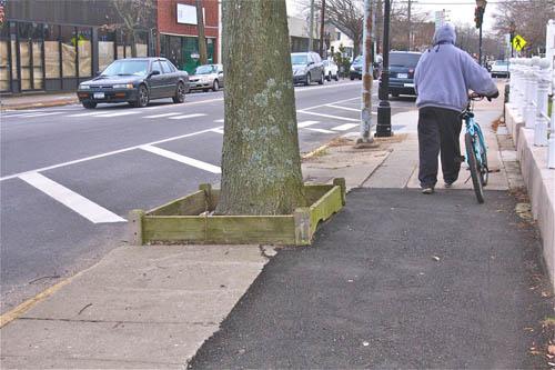 downtown riverhead, east main street, police presence BARBARAELLEN KOCH PHOTO | A pedestrian with a bicycle walks west on East Main Street Friday.