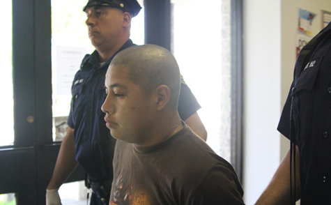 Guillermo Alfonso Alvarado-Ajcuc being led by Riverhead police into Town Justice Court shortly after his arrest. (Credit: Jennifer Gustavson file)