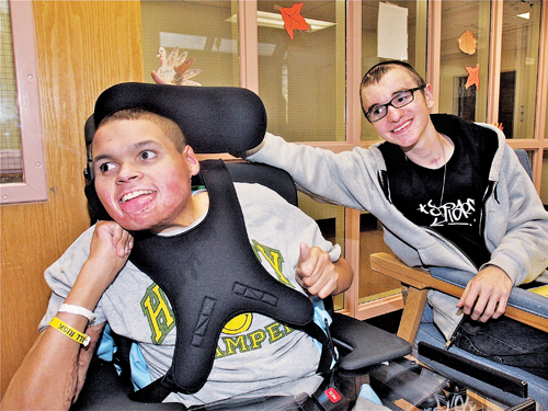 BARBARAELLEN KOCH FILE PHOTO | Michael Hubbard, now being cared for in the Skilled Living Center at PBMC, being visited by Riverhead High School student and Interact Club member Spencer Shea.