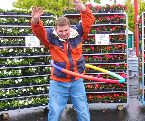 PBMC Health grant writer Max Comando of Jamesport, 24,  tests out the weighted Hula Hoops that will be used Saturday for the kids contest at the Garden Festival from 1 p.m. to 3 p.m. at the Staples Shopping Center on Route 58 in Riverhead.
