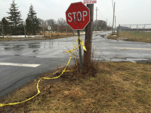 Police tape hangs from a stop sign the morning after the crash. (Credit: Cyndi Murray)