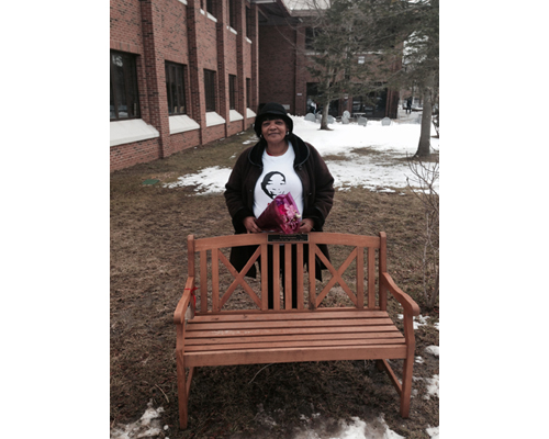 COURTESY PHOTO | Juanita Trent, Demitri Hampton's mother, at a bench dedicated in his honor on the campus of Suffolk County Community College.