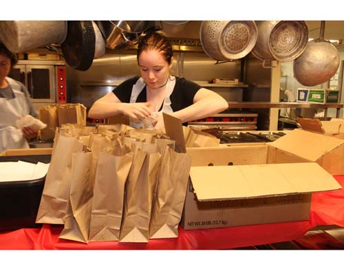 Barbaraellen Koch file photo | Riverhed Senior Center kitchen worker Melissa Muller bags sandwiches before Hurricane Irene.