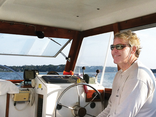 Former baykeeper Kevin McAllister at the wheel on the water. (Credit: Courtesy photo)
