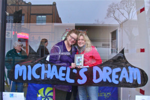 BARBARAELLEN KOCH PHOTO | Nancy Reyer, left, and Allison Pressler, right, at a window display made to recognize Reyer's son, Michael.