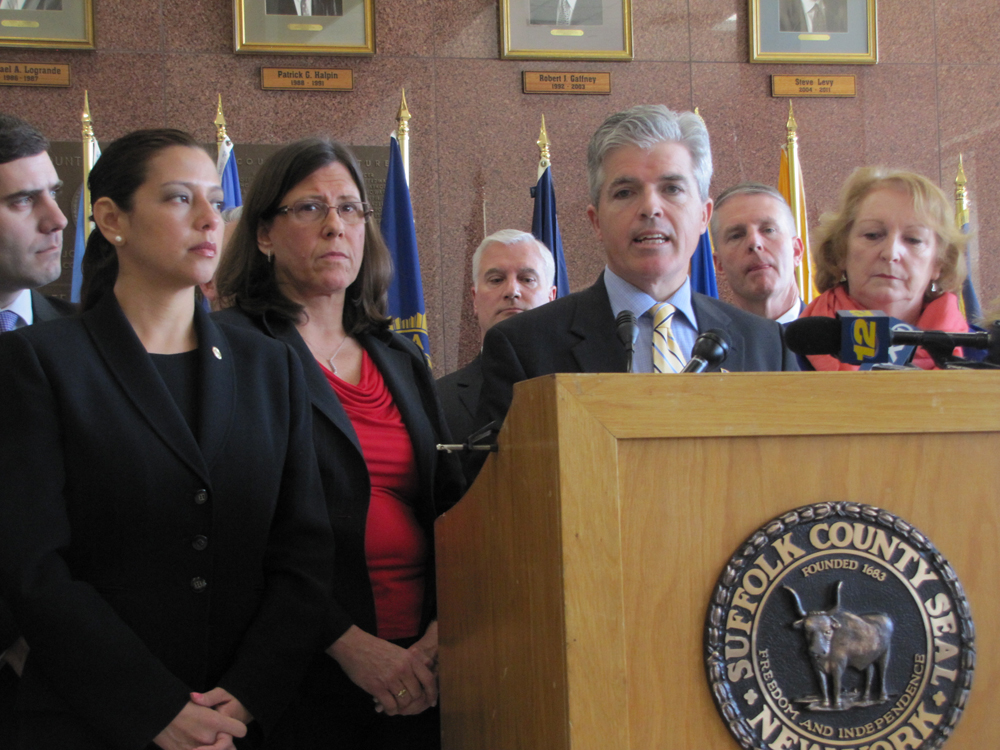 County Executive Steve Bellone (center) touts the benefits of the county's new sex offender monitoring efforts in Hauppauge last week. (Credit: Tim Gannon)