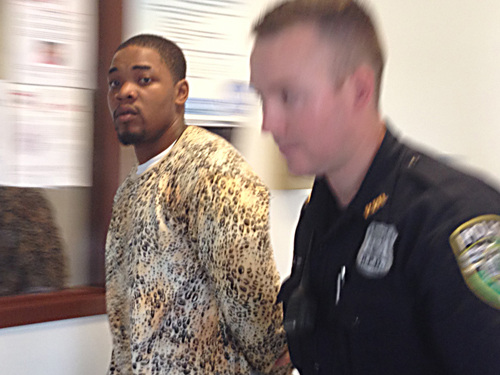 Trendell Walker is led by police out of his arraignment in Riverhead town court Friday morning. (Credit: Paul Squire) 