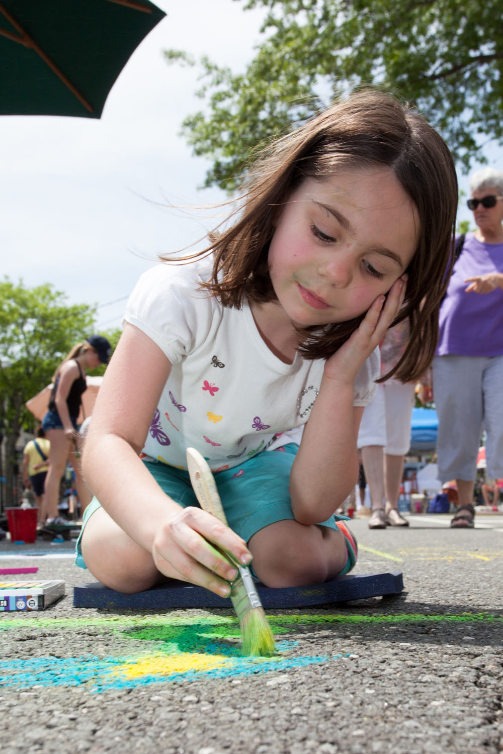Cassidy Masarik, 6, of Manorville, works on her flower painting.