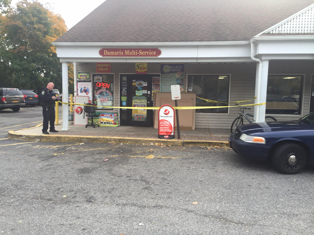 Riverhead Town Police are currently searching for a man who allegedly robbed Damaris Multi-Service on East Main Street on Sunday afternoon. (Credit: Grant Parpan)
