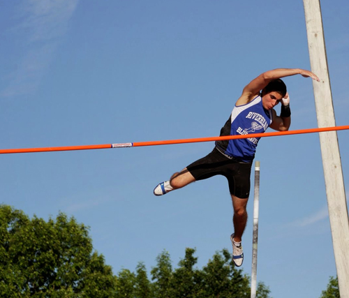 Riverhead senior Charles Villa clears 14 feet 6 inches in the pole vault Friday at the state championships in Syracuse. (Credit: Hal Henty)