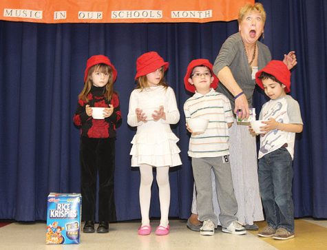 Aquebogue Elementary School first-graders presented an original show by music teacher Marguerite Volonts during last Thursday’s Music in Our Schools Month celebration. Performing with Ms. Volonts are (from left) Kathryn Donohue, Amelia Stevenson, Selvin Valle-Panduro, and Randy Cabrera-Milian.