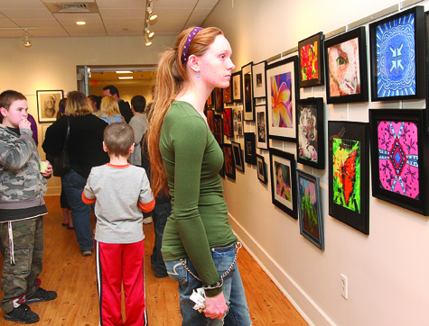 Riverhead High School junior Tanya Rast at the opening reception for Riverhead Free Library's Teen Art Show Friday evening. The show, featuring artwork by RHS students, was dedicated to the memory of art teacher Vincent Nasta.