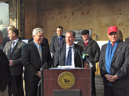 TIM GANNON PHOTO | Michael Butler, center, who heads Woolworth Revitalization LLC, at a press conference on Tuesday to announce grants the project will get from county and state levels of government.