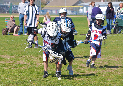 Youth lacrosse players scramble for a ground ball in Riverhead. Parents are proposing an artificial turf field be built at EPCAL. (Credit: Barbaraellen Koch, file)
