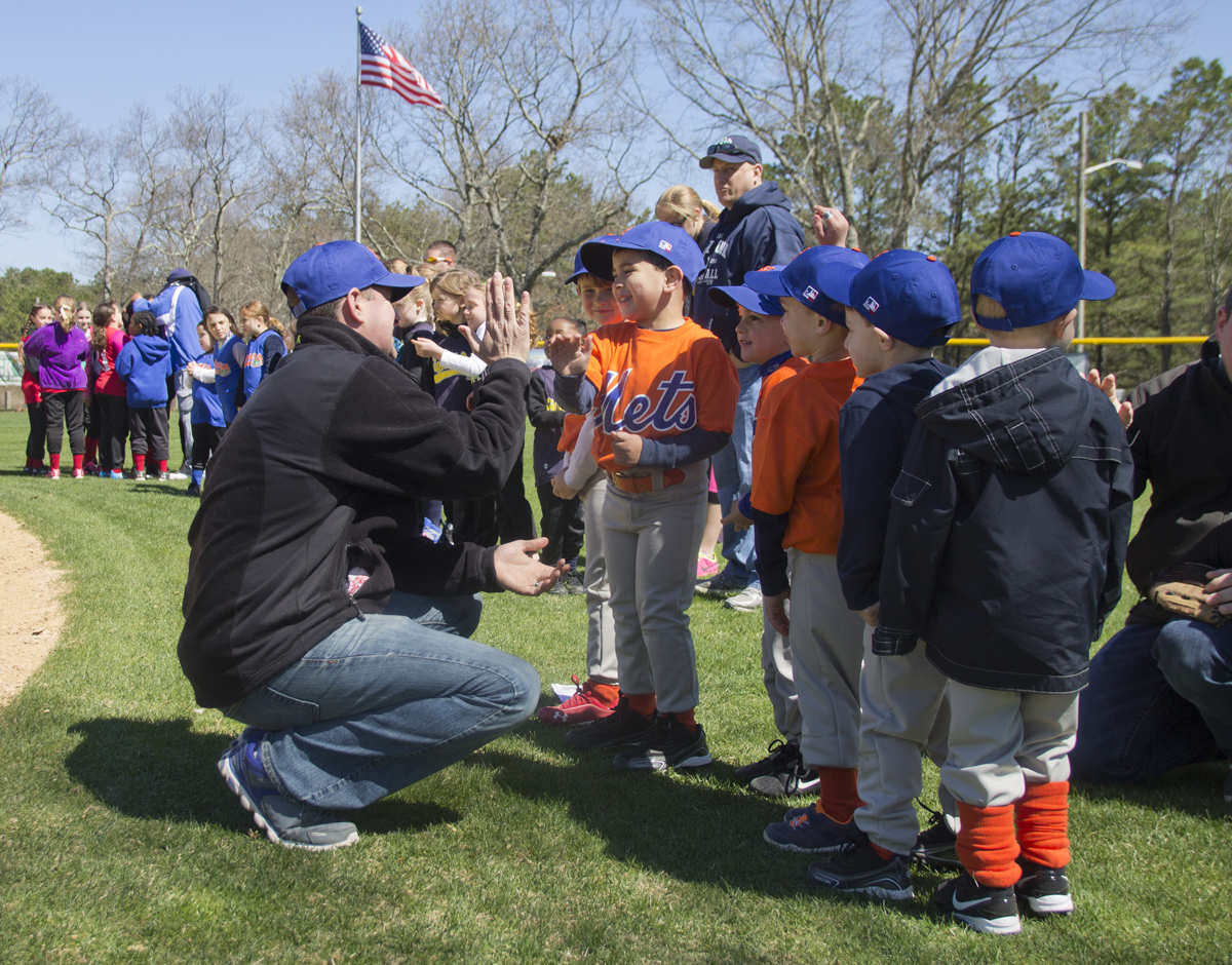 Members of the Mets T-ball team high five during Opening Day. (Credit: Paul Squire)