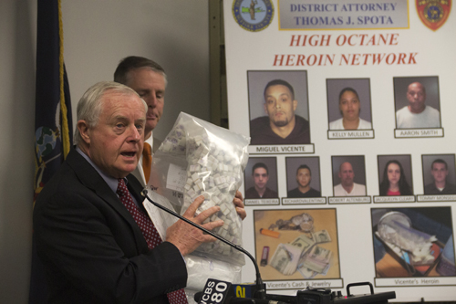 Suffolk County District Attorney Thomas Spota holds up a bag of heroin seized during a drug raid that busted an alleged heroin network. (Credit: Paul Squire)