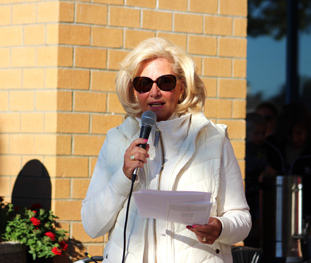 Janine Nebons, general manager of Tanger Outlets, thanks sponsors and instructs crowd about the walk.
