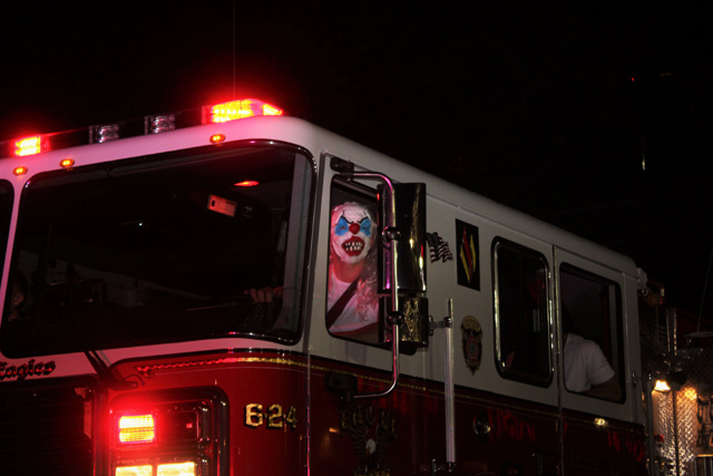 A creepy clown steering the Riverhead Fire Department truck. 