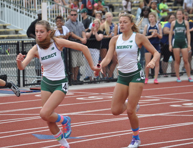 McGann-Mercy senior Delaney Macchirole hands off to Dayna Young in the 4x400 relay Friday. (Credit: Joe Werkmeister)