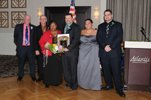 (Courtesy photo) Lifetime achievement award winner Betty Harris (third from left) accepts her award with Corps board members Ron Rowe, Keith Lewin, Bruce Talmage and Kim Pokorney and Chief Joseph Oliver at the corps' dinner Saturday night. 