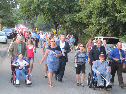 The procession walks along Park Road in Reeves Park toward the 9/11 Memorial at the corner of Park and Sound Avenue during last year's procession. (Credit: Tim Gannon)