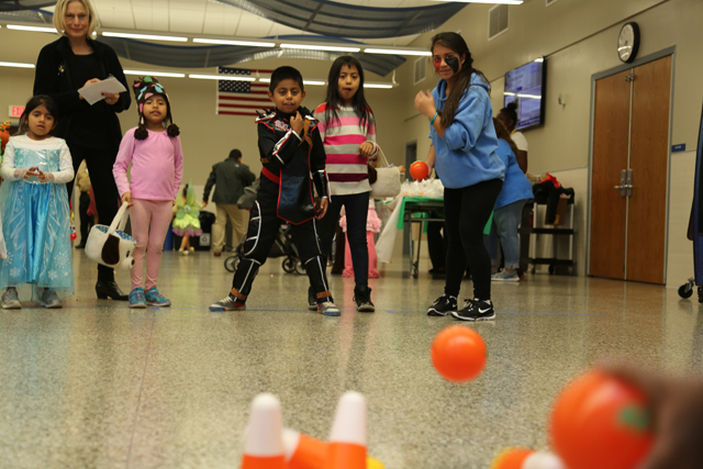 Nine-year-old Luis Aguilar from Aquebogue bowls down candy corn pins at Riverhead High School Key Club's Safe Halloween event.