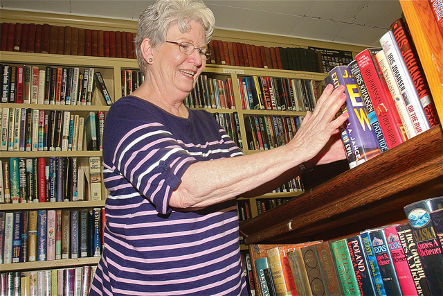 Thelma Stanza has been busy alphabetizing the books inside the tiny Baiting Hollow Library. (Credit: Barbaraellen Koch)