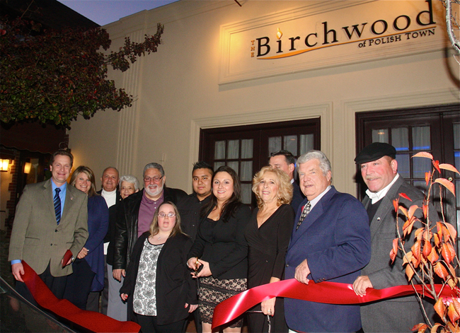Danielle Sessa (fifth from right) cut the ribbon with family and town officials Monday afternoon to Birchwood of Polish Town. (Credit: Barbaraellen Koch)