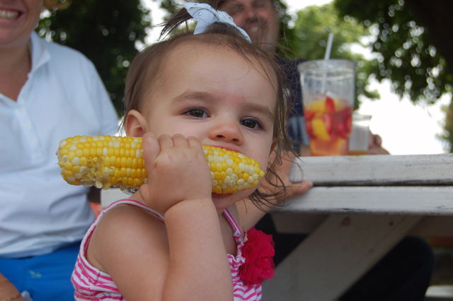 Ashlyn Galante, 2, of Mineola chows down at the Harbes Sweet Corn Festival on Sunday. (Credit: Vera Chinese)