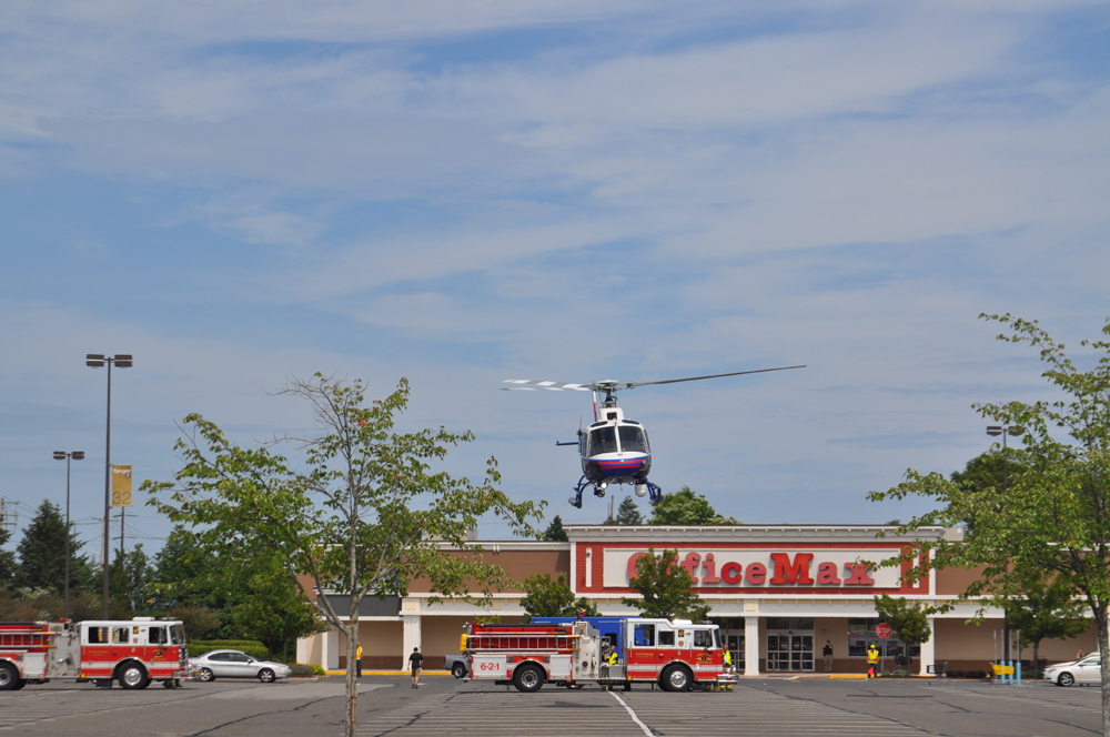 A police helicopter lands in front of Office Max on Route 58. (Credit: Joe Werkmeister)