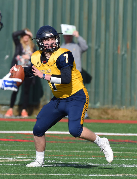 Shoreham-Wading River quarterback Kevin Cutinella throws a pass early in Saturday's semifinal win.