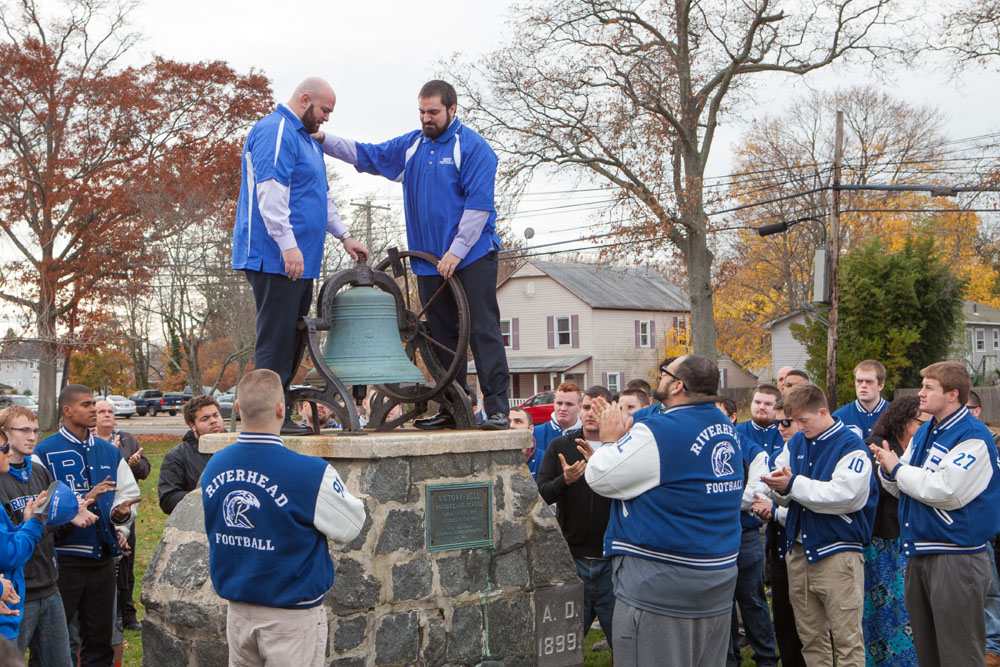 Brian and Daniel DeCabia ring the 'Victory Bell' 15 times in memory of their father. (Credit: Katharine Schroeder)