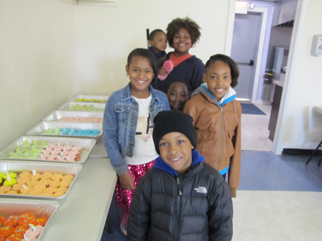Tyre Lodge Conductress Theodora Midgette, in the back, checking out the cupcakes  with youngsters  Zehki Stephens, Zhirin Stephens (hidden in the middle), Anariynan Williams, Preston Gamble and Egypt Dozier at Saturdays's Easter Egg hunt. 