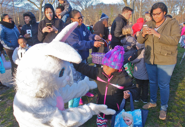 Journey Moore of Riverhead, 4, meets the Easter Bunny on her first egg hunt Friday evening. (Credit: Barbaraellen Koch)