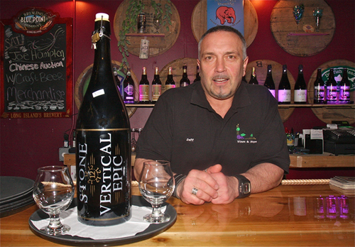 Jeff McKay, co-owner of Vines & Hops Café in Riverhead, with the store’s remaining bottle of the 2012 Vertical Epic brew, currently on sale for $200. (Credit: Barbaraellen Koch) 