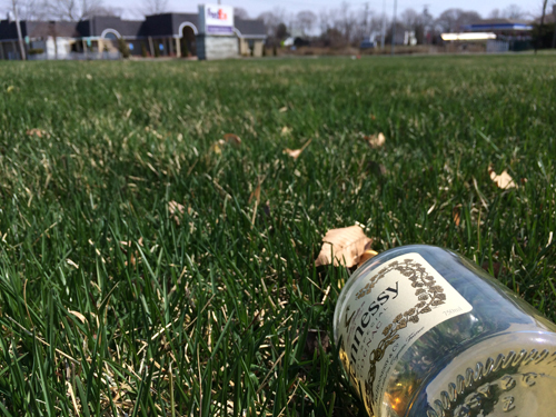 A leftover bottle of Hennessy lies on the ground outside Cinco De Mayo Sunday morning after a fight broke out involving nearly 100 people. (Credit: Grant Parpan)