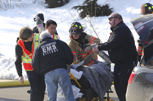 Rescue workers aid one of the victims in the explosion in Water Mill yesterday. (Credit: The Southampton Press/Dana Shaw)