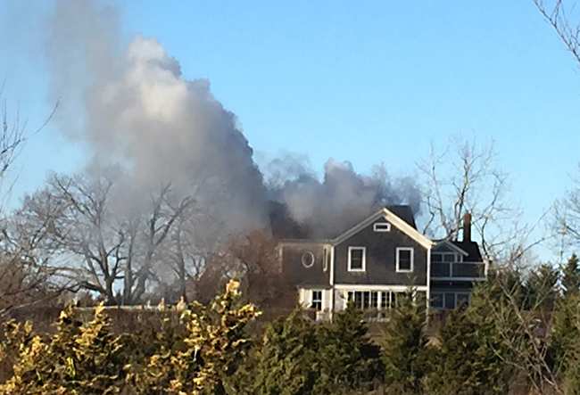 Smoke billowing from a home in Calverton Saturday afternoon. (Credit: Melanie Drozd)