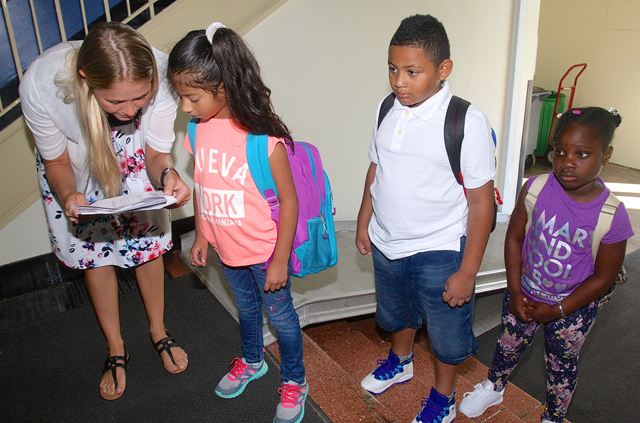ENL tacher Diana Leifsson helps second grader Brianna Carrillo find her teacher.