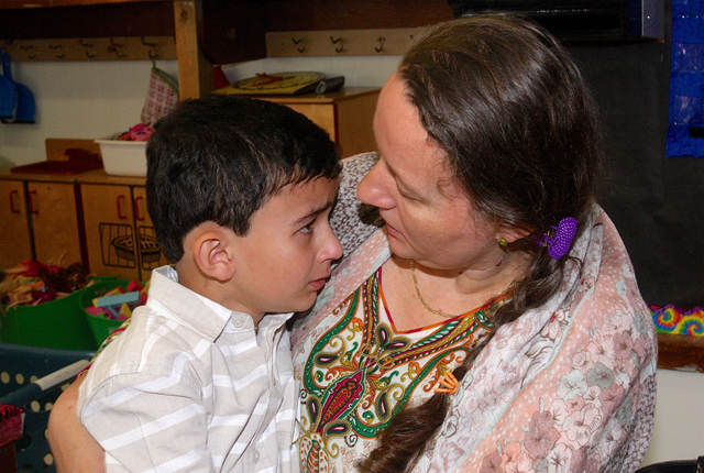 Elizabeth Przyborowska comforts her son Ibrahaim, 5, in his kindergarten classroom.