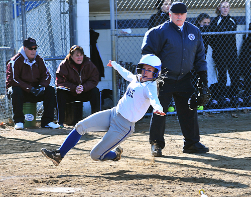 Riverhead's Sarah Freeborn slides into home plate to score a run against Kings Park. (Credit: Robert O'Rourk)