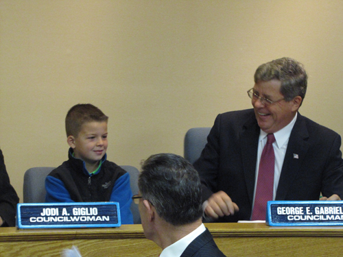 Councilman George Gabrielsen was joined by grandson Robert, 9, at his last meeting Thursday. (That's Town Attorney Bob Kozakieiwicz in front, no doubt giving Robert some legal advice)