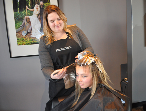 Stylist Ashley Fogerty gives Grace Kaelin of Aquebogue highlights Saturday afternoon at Gabriel Loren the Salon in Riverhead. (Credit: Rachel Young)