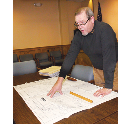 Planning director Rick Hanley looking over Lowes' site plan for the former Suffolk Life building on Route 58 in 2009. (Credit: Barbaraellen Koch)