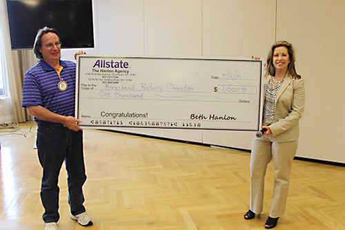 Allstate agent Elizabeth Hanlon (right) presents a check to Riverhead Rotary president Tom Lennon. (Credit: Courtesy photo)